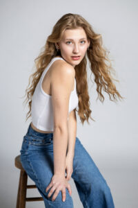 Senior girl posing in studio with white modern backdrop in Utah.