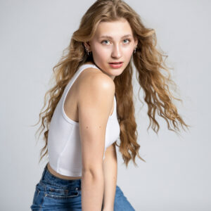 Senior girl posing in studio with white modern backdrop in Utah.