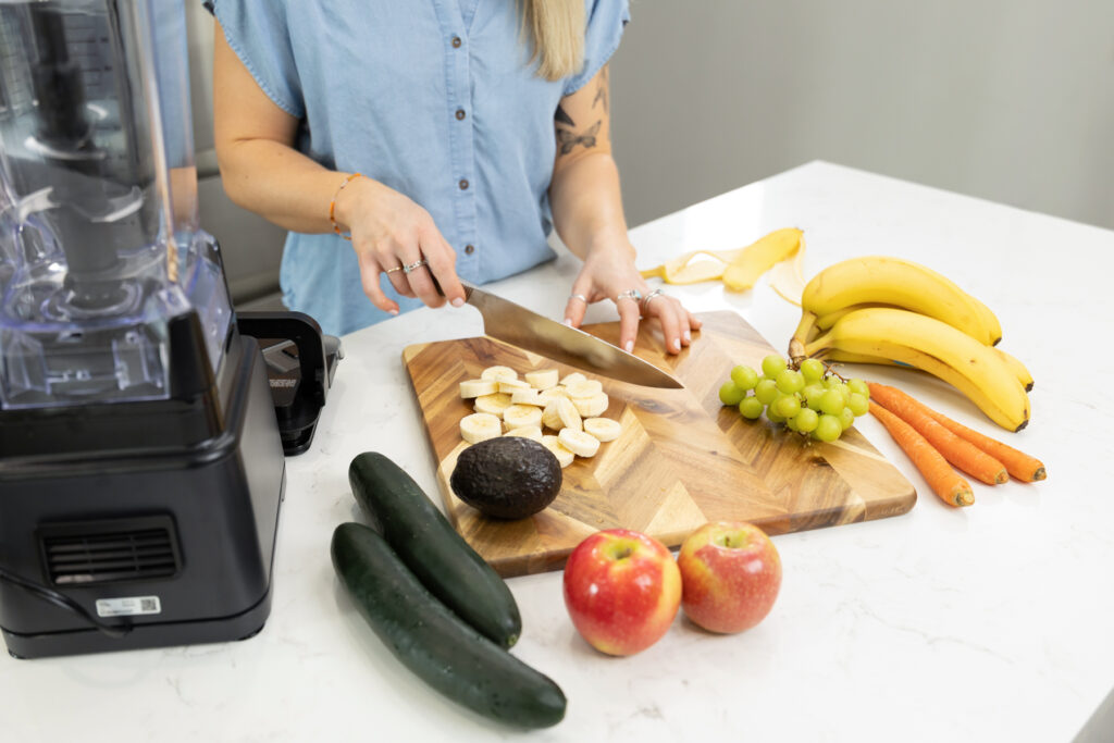 Woman cutting a banana on a cutting board for scene in branding session in Utah.