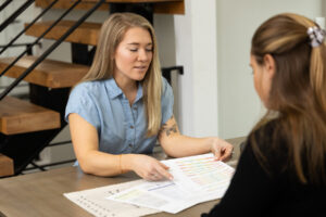 Woman looking at test results with client during photoshoot in Utah.