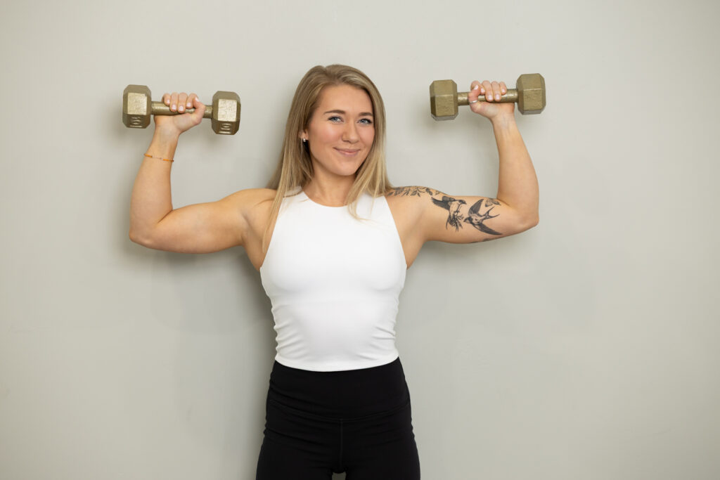 Woman holding dumbbells during a brand photoshoot in Utah.