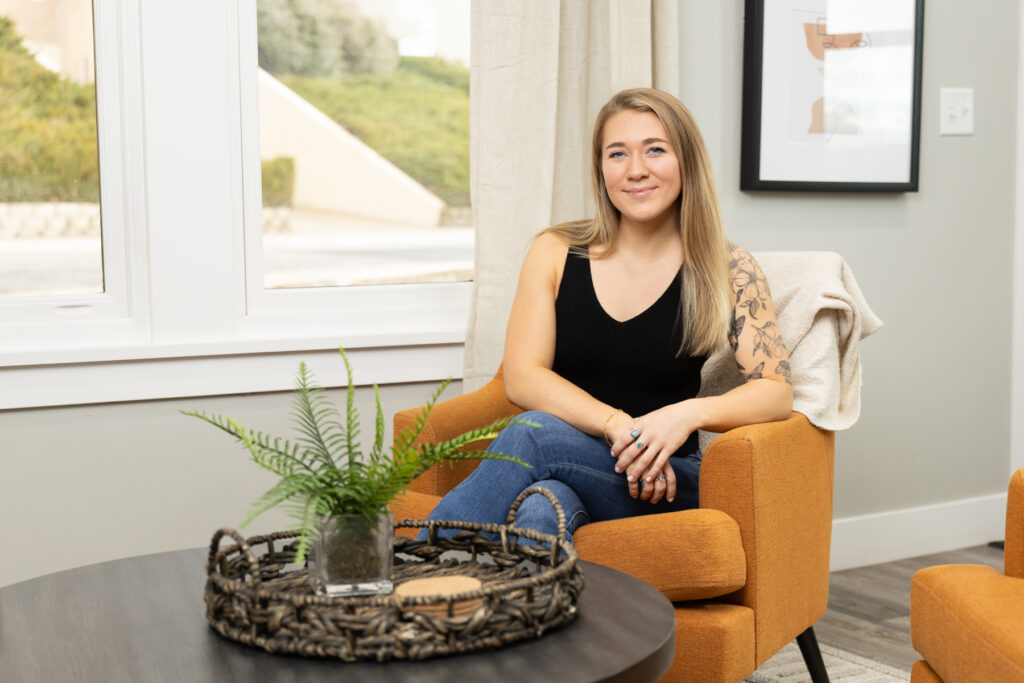 Woman sitting in living room during brand session in Utah.