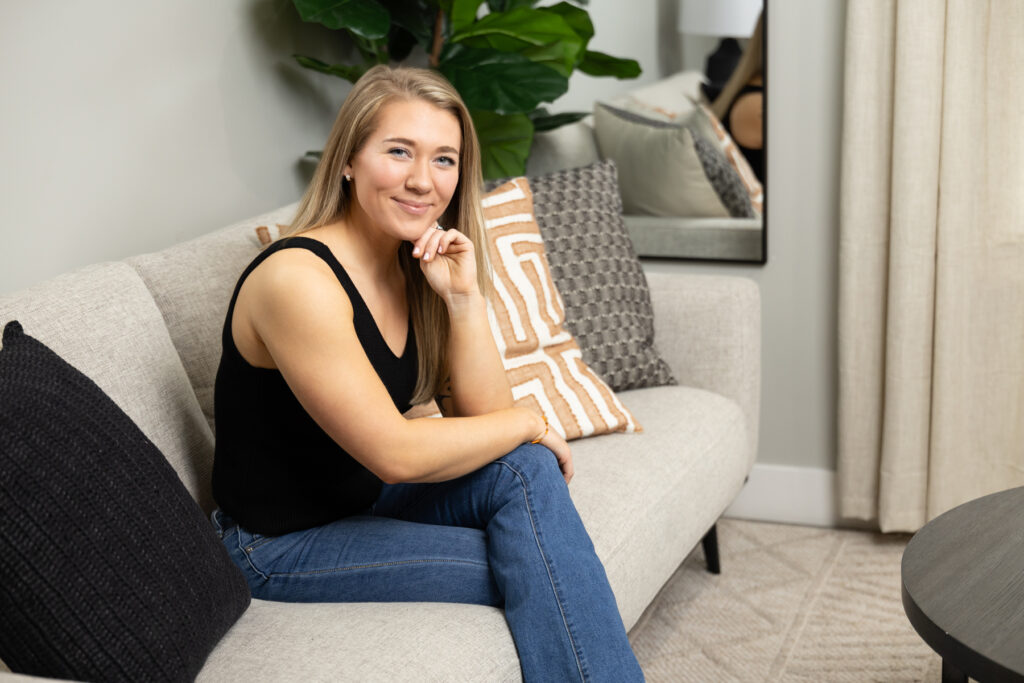 Woman sitting on couch in living room for portrait with Utah Brand Photographer Sara Vaz.