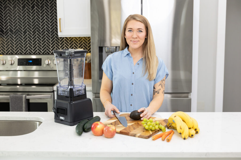 Picture of woman making a smoothie in a kitchen in Utah during a branding photography session.