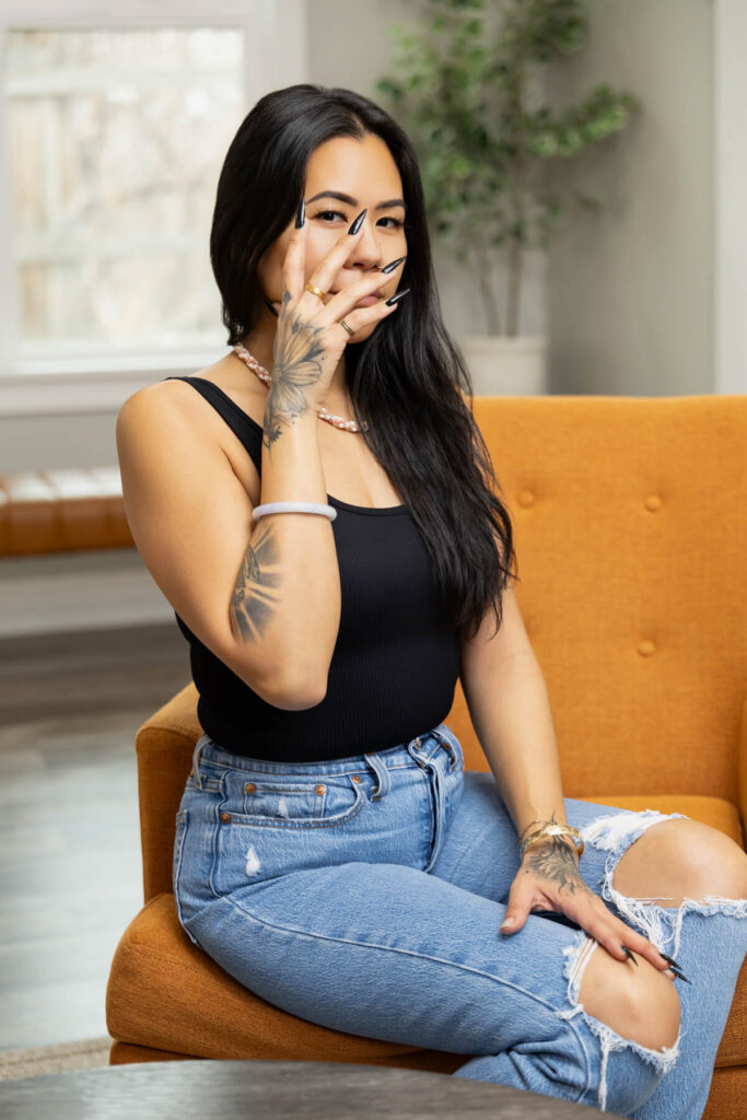 Woman with her long black nails covering her face during a branding session with Sara Vaz Photography.