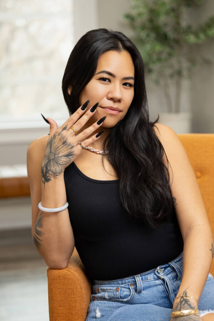 Woman showing off her long black nails during a brand shoot in Utah.