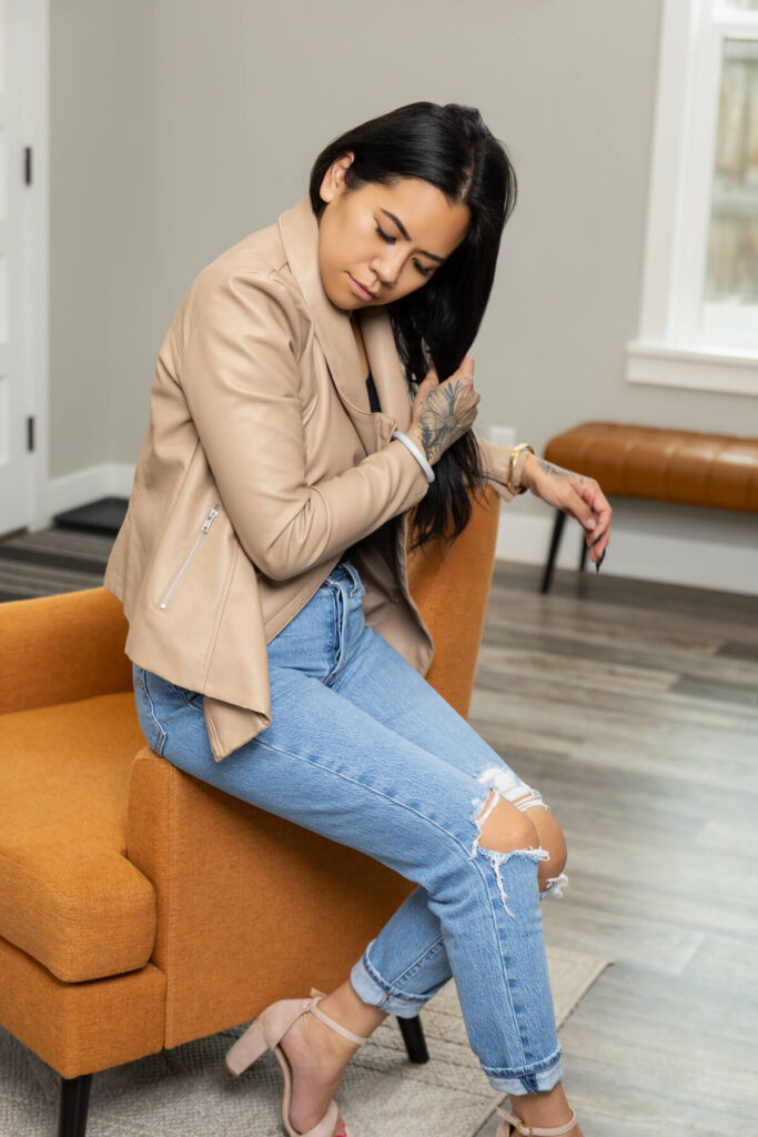 Woman fixing her hair during her brand session in Utah at a modern Salt Lake City home.