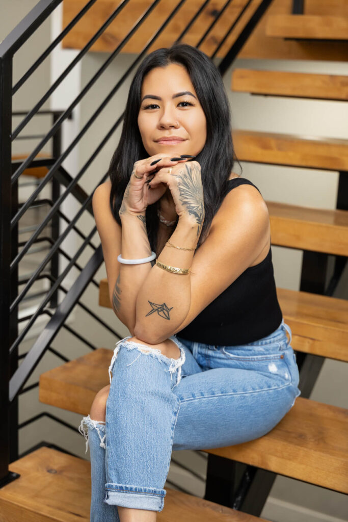 Woman posing with her hands together on the stairs for her branding session in Utah.